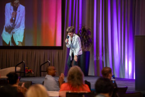 Joan Burge speaking to an audience of administrative professionals