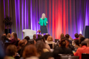 Alexandra Von Tiergarten presenting how to future-proof your administrative career on stage at the Conference for Administrative Excellence.