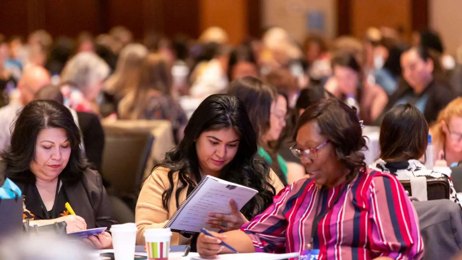 Executive assistants engaged in experiential learning activities at conference