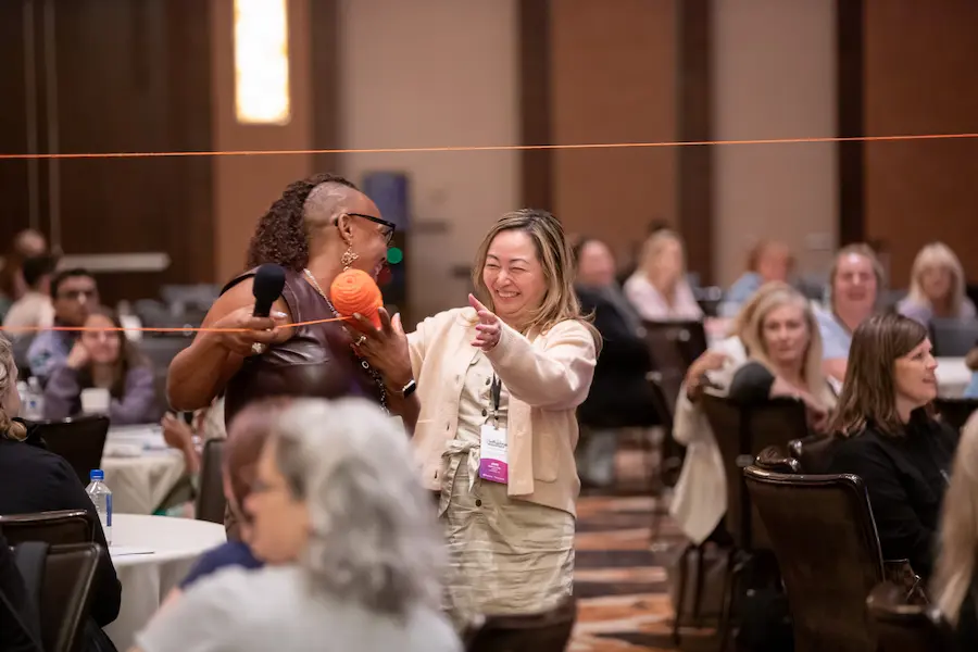 experiential learning conference attendees enjoy an interactive session with orange yarn